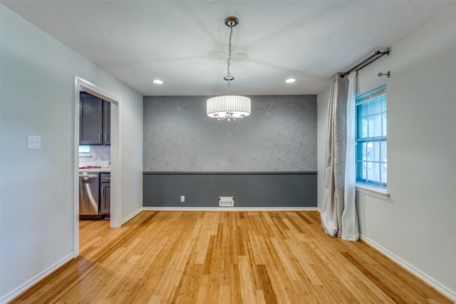 unfurnished dining area featuring light hardwood / wood-style flooring