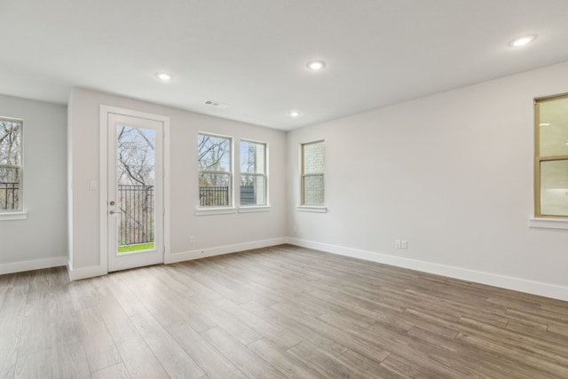 unfurnished room with light hardwood / wood-style flooring and a wealth of natural light