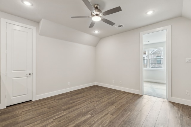 unfurnished room featuring lofted ceiling, dark wood-type flooring, and ceiling fan