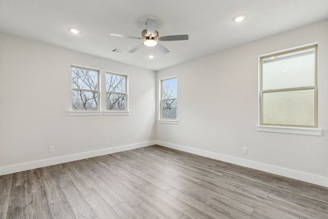 unfurnished room with ceiling fan and light wood-type flooring