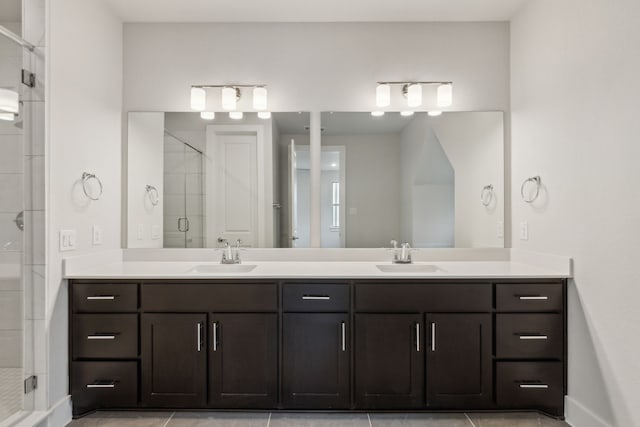 bathroom featuring a shower with door and vanity