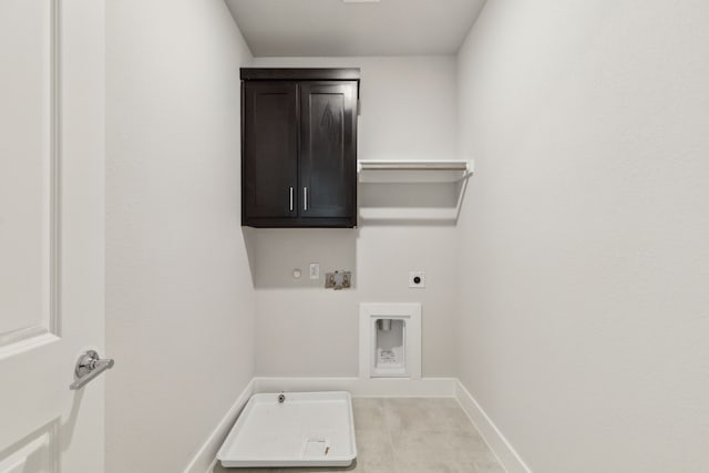 clothes washing area featuring gas dryer hookup, cabinets, washer hookup, and hookup for an electric dryer