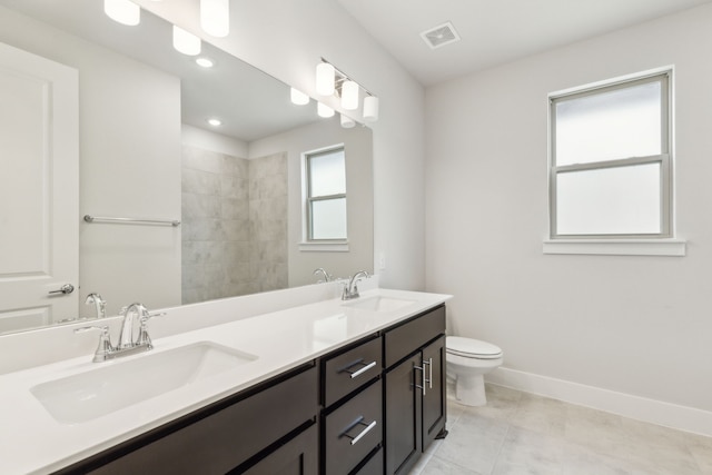 bathroom featuring vanity, toilet, and tile patterned flooring