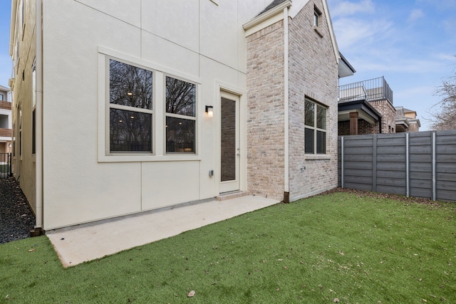 view of home's exterior featuring a patio and a yard