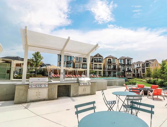 view of patio featuring an outdoor kitchen, grilling area, and a pergola