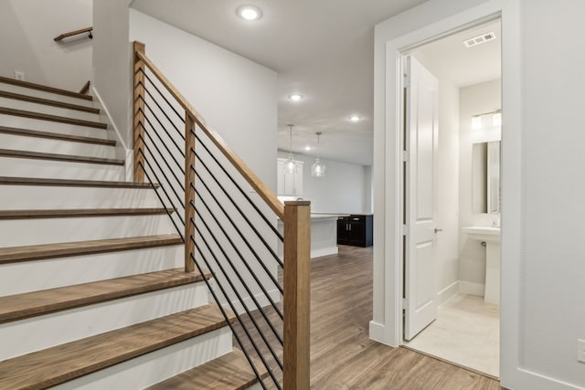 stairway featuring hardwood / wood-style floors