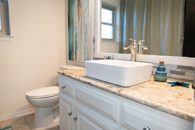 bathroom featuring vanity, tile patterned floors, and toilet