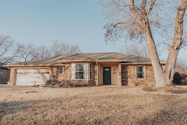 single story home featuring a garage and a front lawn