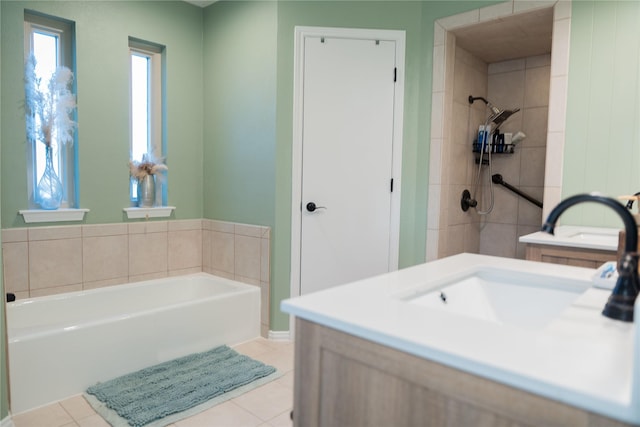 bathroom featuring tile patterned flooring, vanity, and a tub