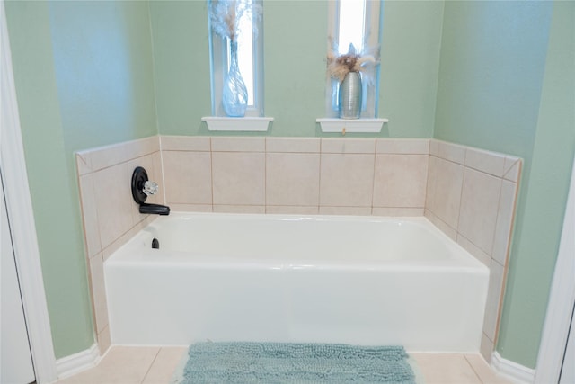 bathroom with tile patterned flooring and a bathtub