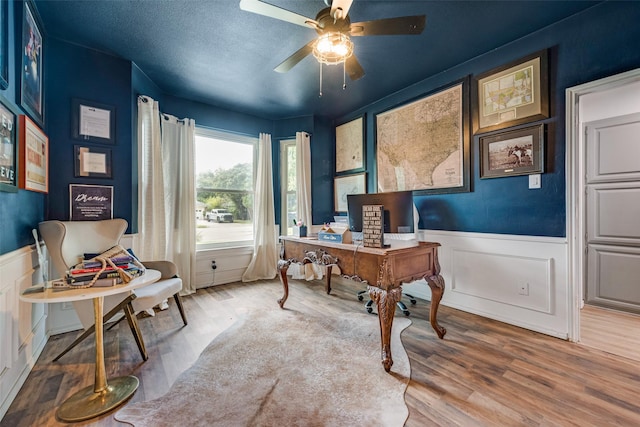 office featuring hardwood / wood-style flooring, ceiling fan, and a textured ceiling