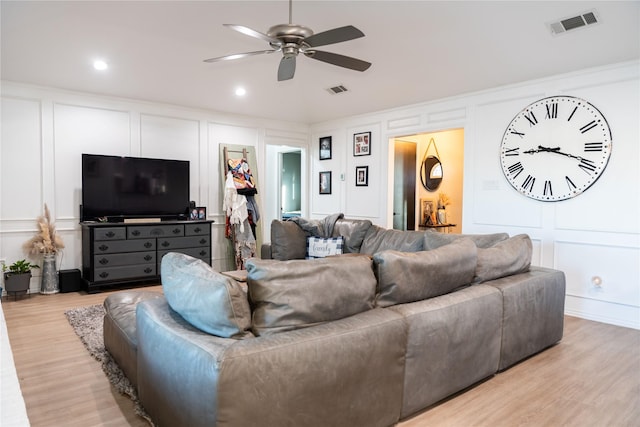 living room with ceiling fan and light hardwood / wood-style floors