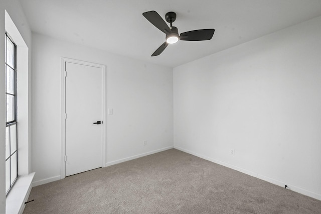 spare room with light carpet and ceiling fan