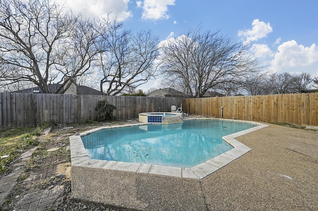 view of pool with an in ground hot tub