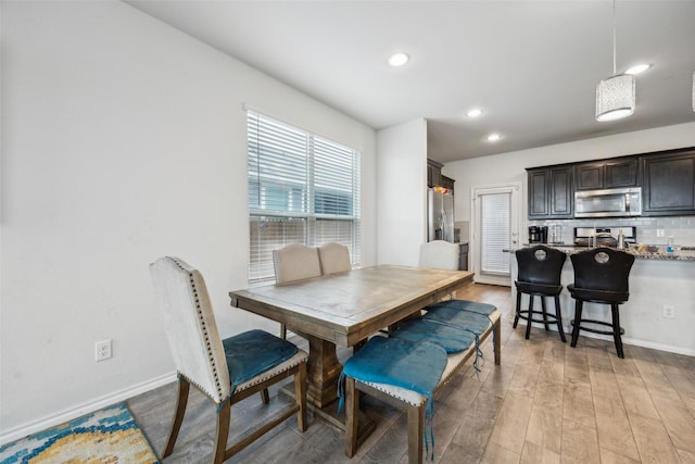 dining room with sink and light hardwood / wood-style floors