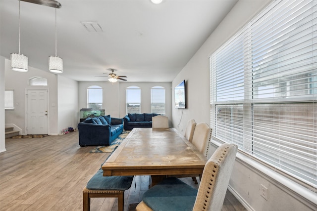 dining space featuring ceiling fan and light wood-type flooring