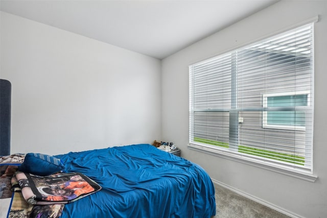 carpeted bedroom featuring multiple windows