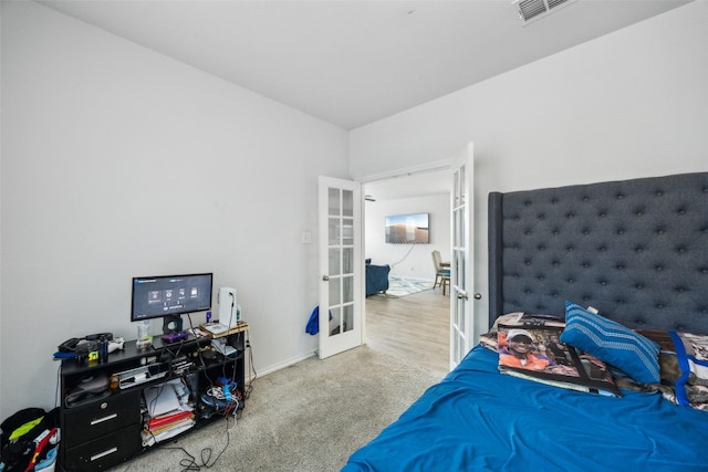 carpeted bedroom with french doors