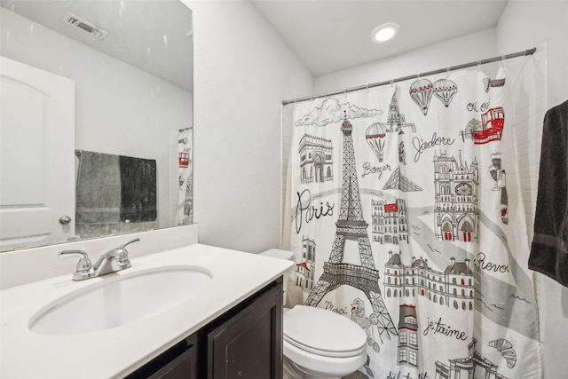 bathroom featuring vanity, toilet, and a shower with shower curtain