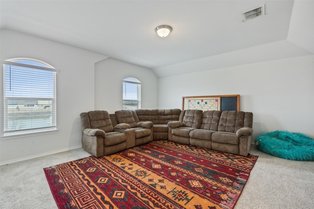 carpeted living room featuring vaulted ceiling