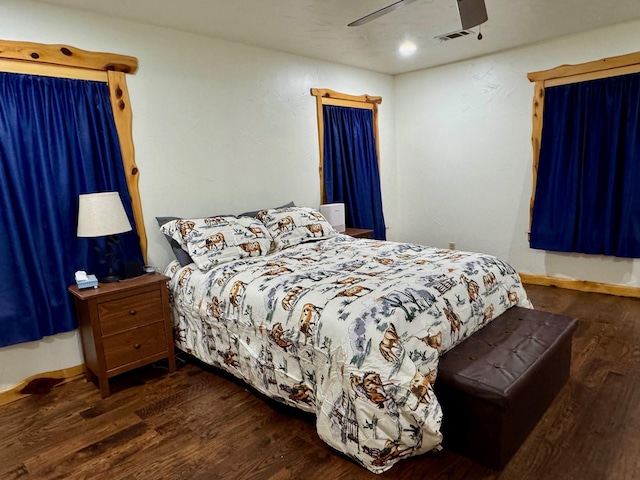 bedroom with ceiling fan and dark hardwood / wood-style flooring