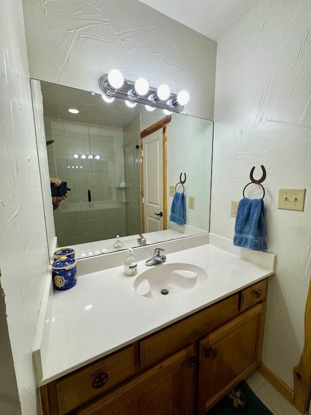 bathroom with vanity and a shower with shower door