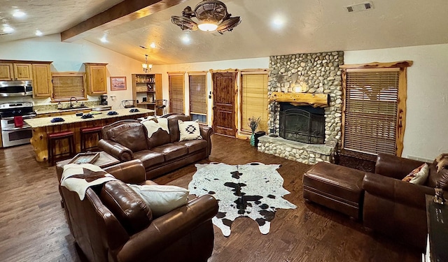 living room with dark wood-type flooring, a fireplace, and lofted ceiling with beams