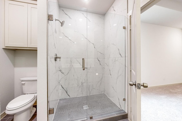 bathroom featuring a marble finish shower, toilet, and baseboards