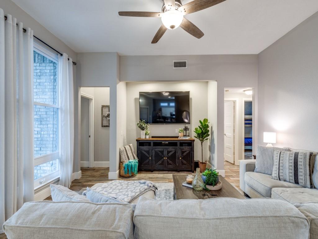 living room featuring ceiling fan, light hardwood / wood-style floors, and a healthy amount of sunlight