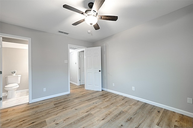 unfurnished bedroom with connected bathroom, light hardwood / wood-style flooring, and ceiling fan