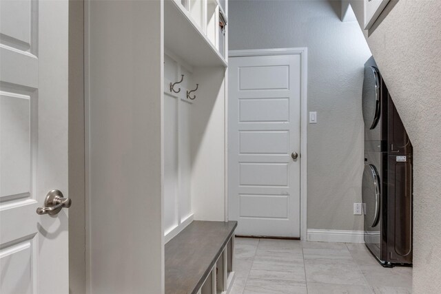 mudroom with stacked washer / drying machine