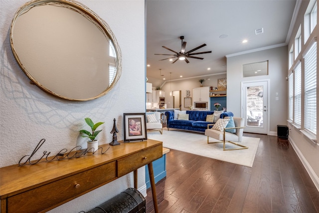 living room featuring crown molding, ceiling fan, and dark hardwood / wood-style floors