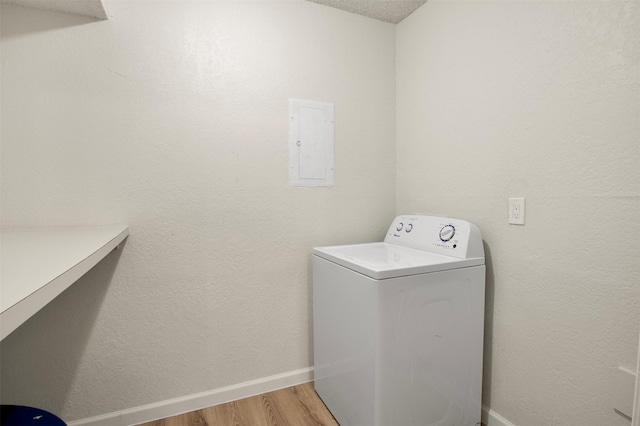 laundry area with washer / dryer, wood-type flooring, and electric panel