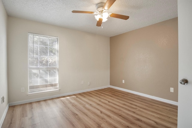 empty room featuring ceiling fan, a textured ceiling, and light wood-type flooring