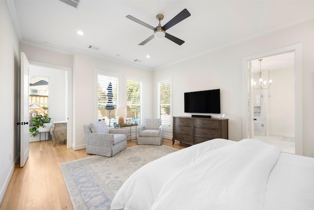 bedroom featuring crown molding, ceiling fan, wood-type flooring, and ensuite bath