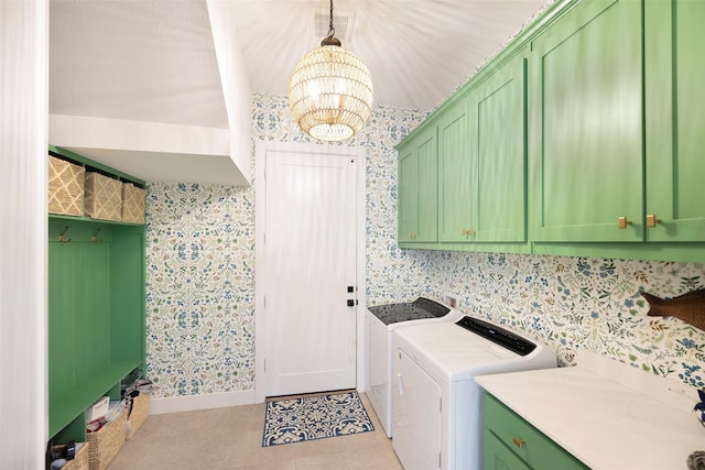 laundry room featuring cabinets, a chandelier, light tile patterned floors, and independent washer and dryer