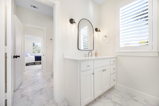 bathroom featuring vanity and a wealth of natural light