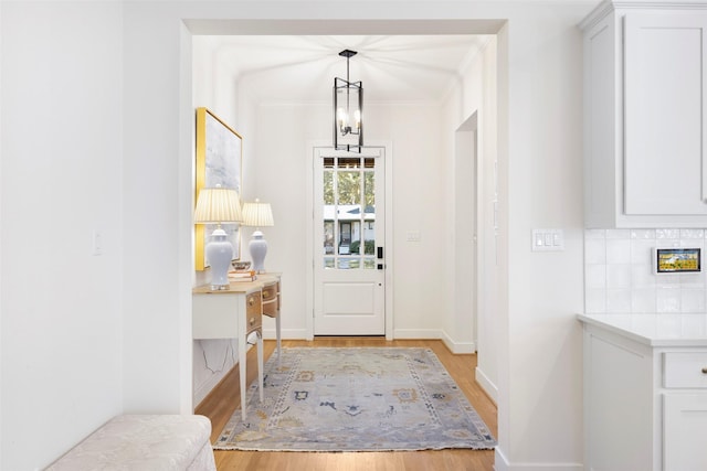 entrance foyer featuring a notable chandelier and light hardwood / wood-style floors