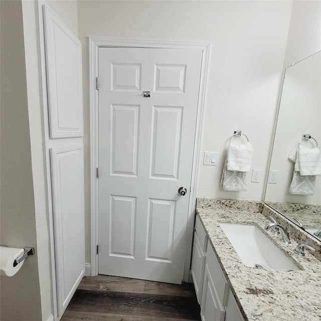 bathroom with vanity and hardwood / wood-style flooring