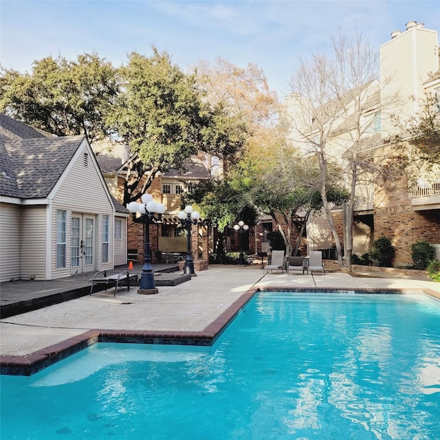 view of pool with a patio and french doors