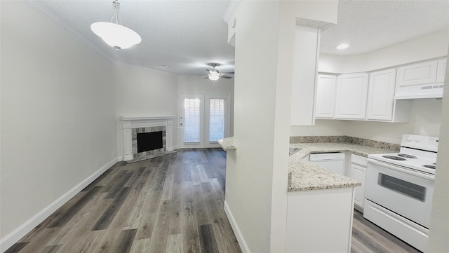 kitchen with decorative light fixtures, white electric stove, white cabinetry, a premium fireplace, and a textured ceiling