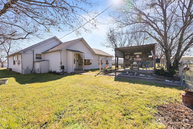 back of property featuring a yard and a pergola