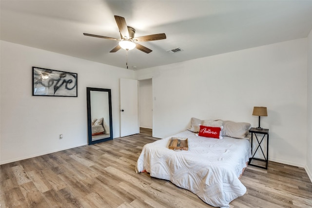 bedroom with hardwood / wood-style flooring and ceiling fan