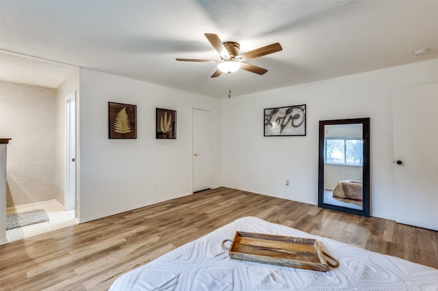 bedroom with light hardwood / wood-style floors and ceiling fan