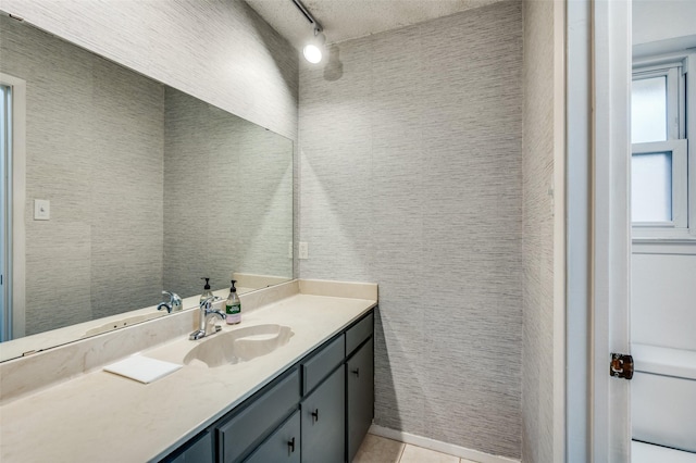 bathroom featuring vanity, rail lighting, tile walls, and tile patterned floors