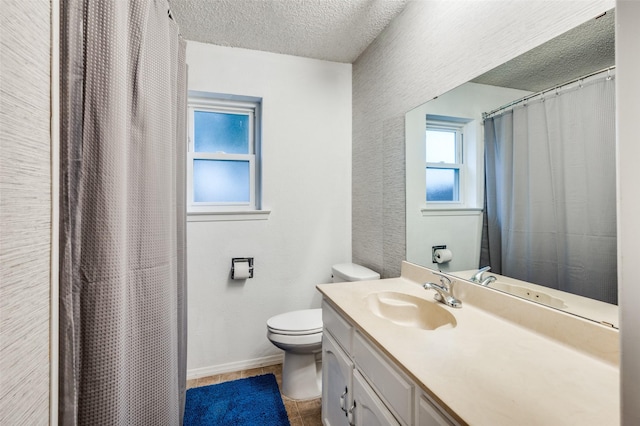 bathroom featuring vanity, toilet, and a textured ceiling