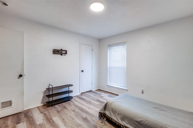 bedroom with light wood-type flooring