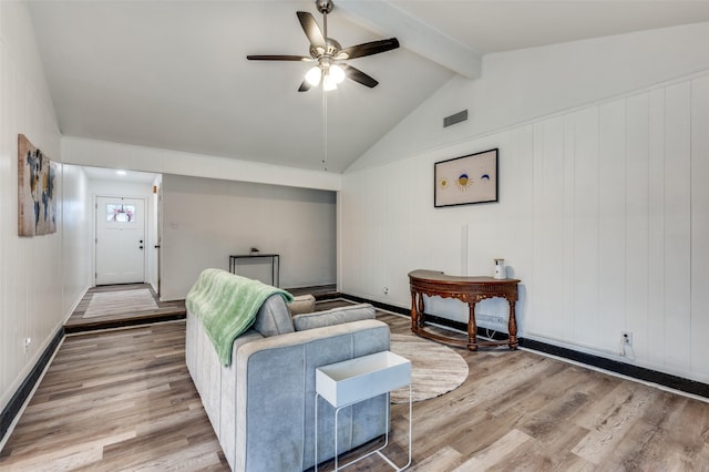 living room featuring hardwood / wood-style floors, vaulted ceiling with beams, and ceiling fan