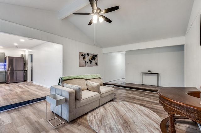 living room featuring hardwood / wood-style flooring, ceiling fan, and lofted ceiling with beams