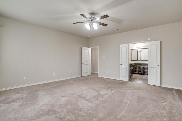 carpeted spare room featuring a wealth of natural light and ceiling fan